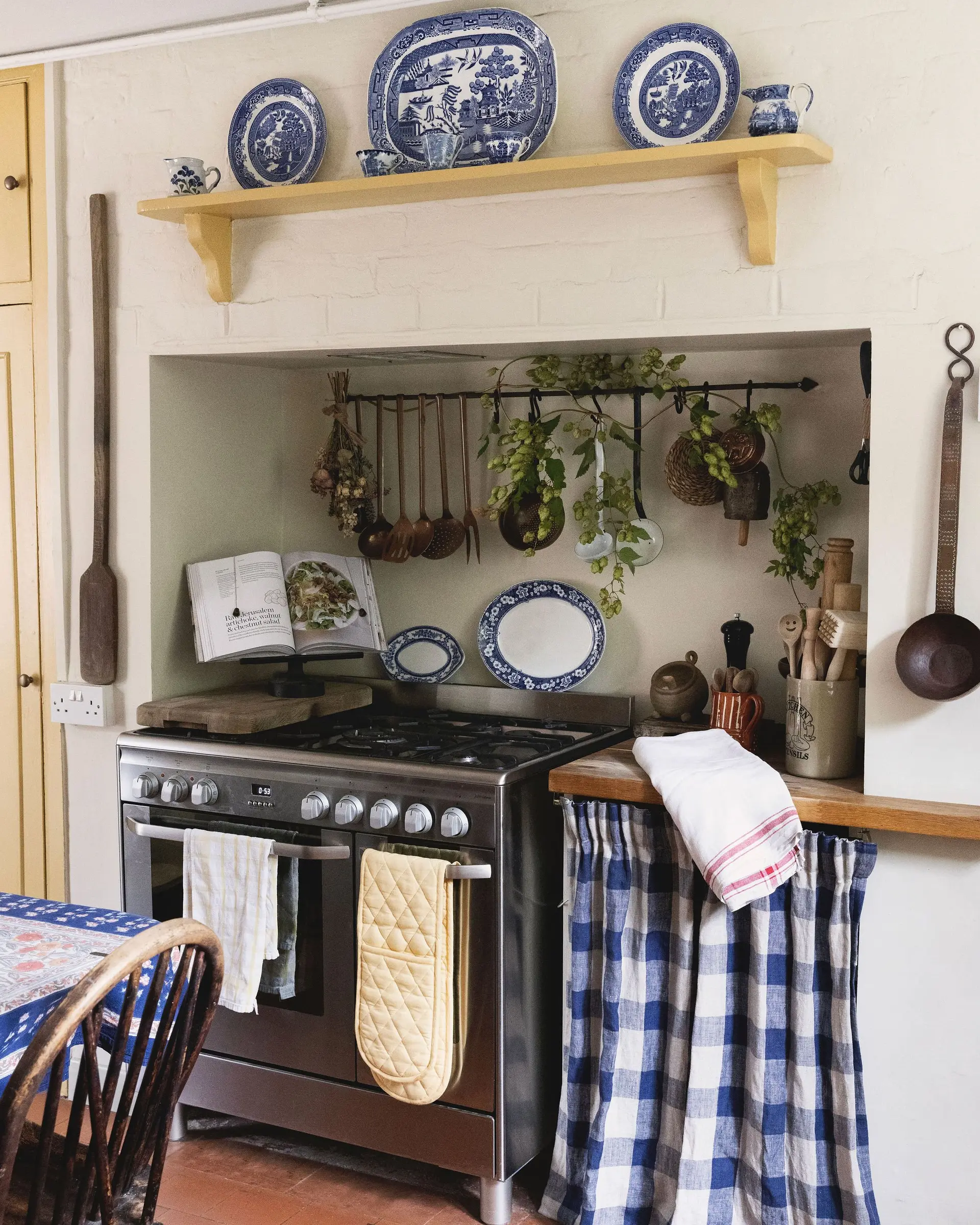 Country cottage kitchen with gingham curtains and blue-and-white china