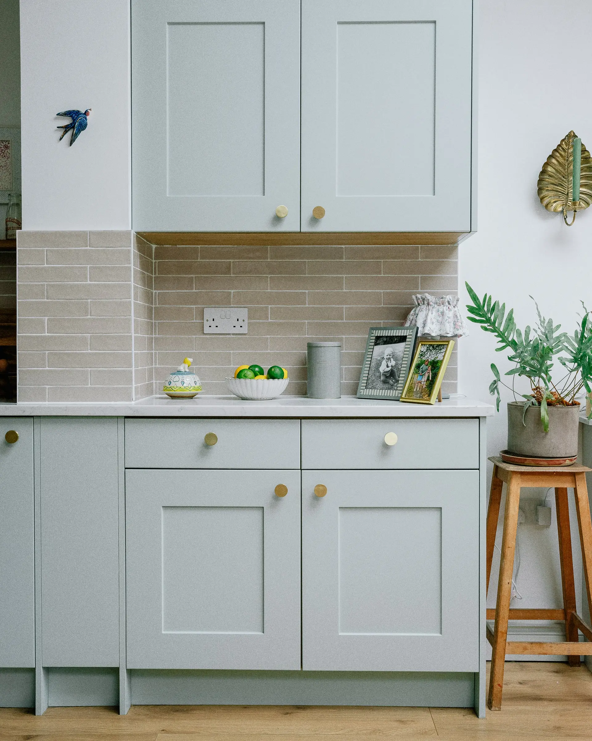 Duck-egg blue shaker kitchen with brass handles