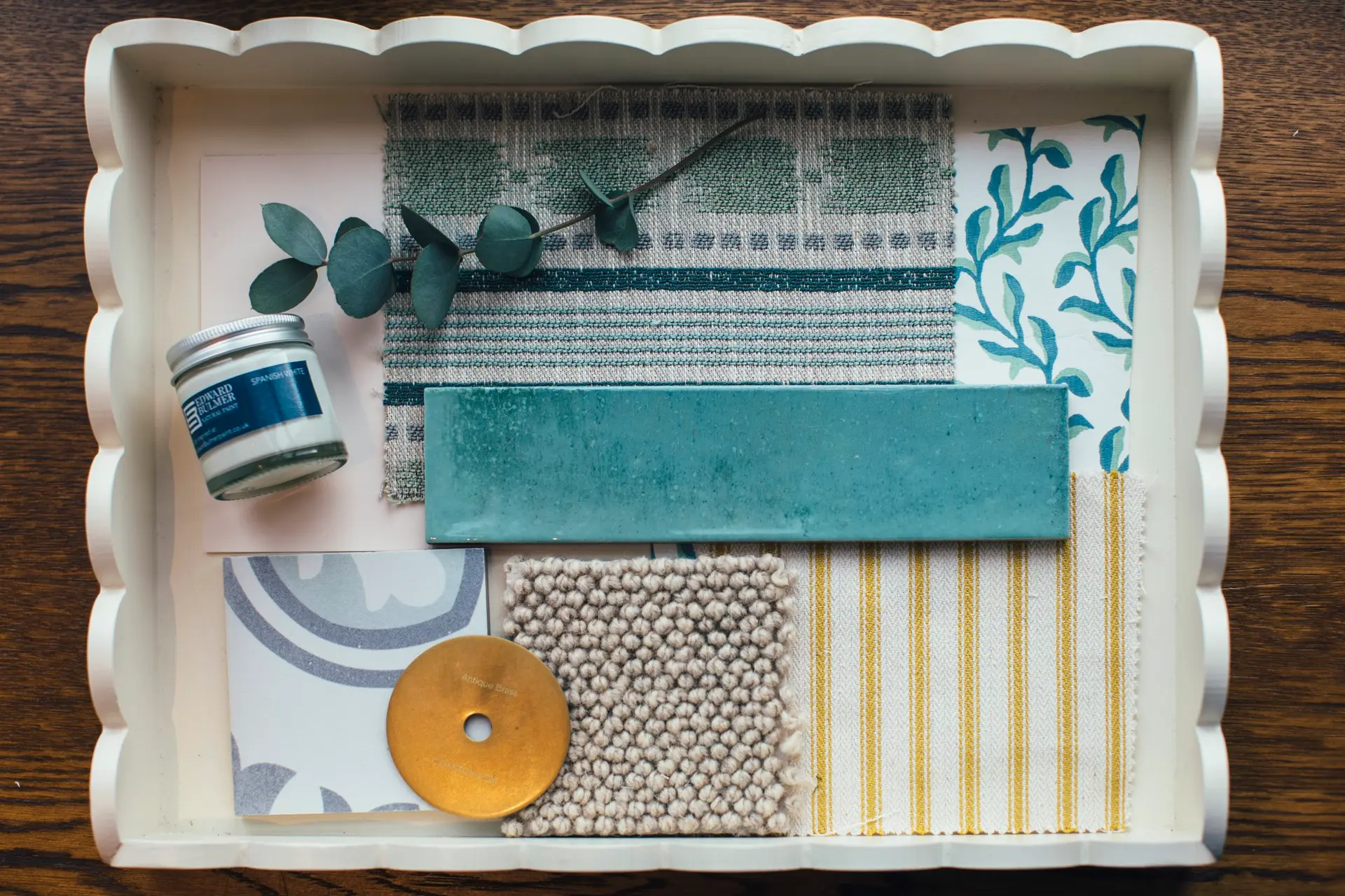 Concept board of fabrics, tiles and samples in soft teal