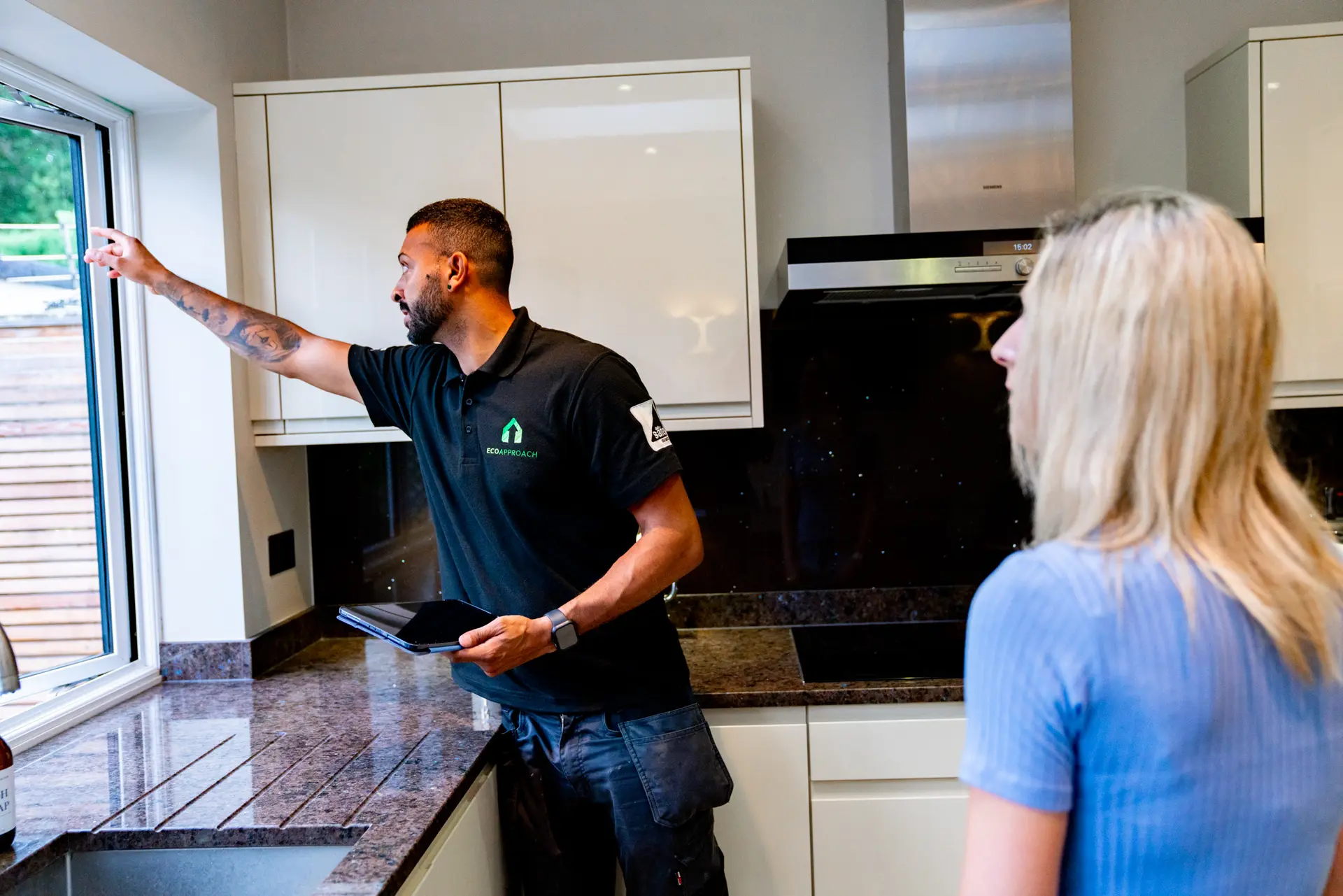 An Eco Approach assessor with a homeowner in her kitchen