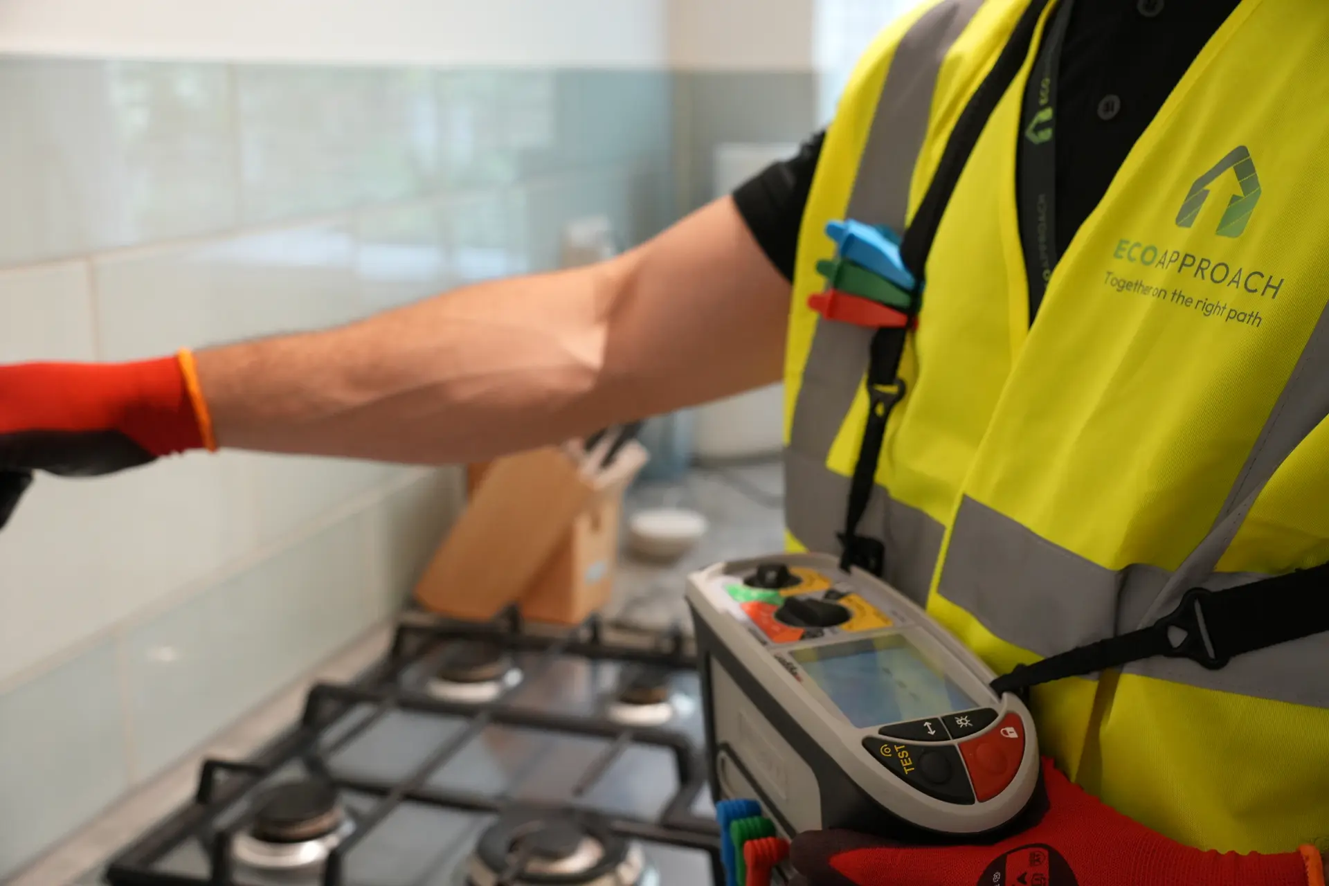 An engineer testing a gas hob with a meter