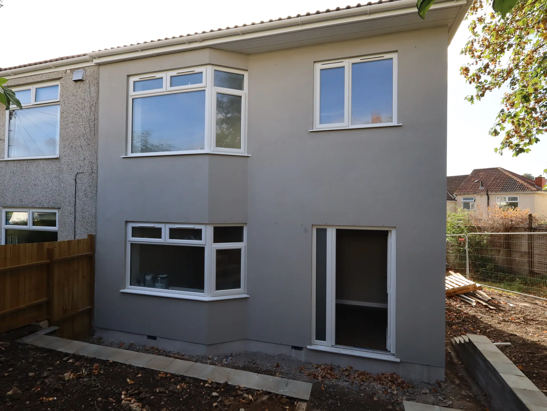 Finished rear elevation with grey render and new windows