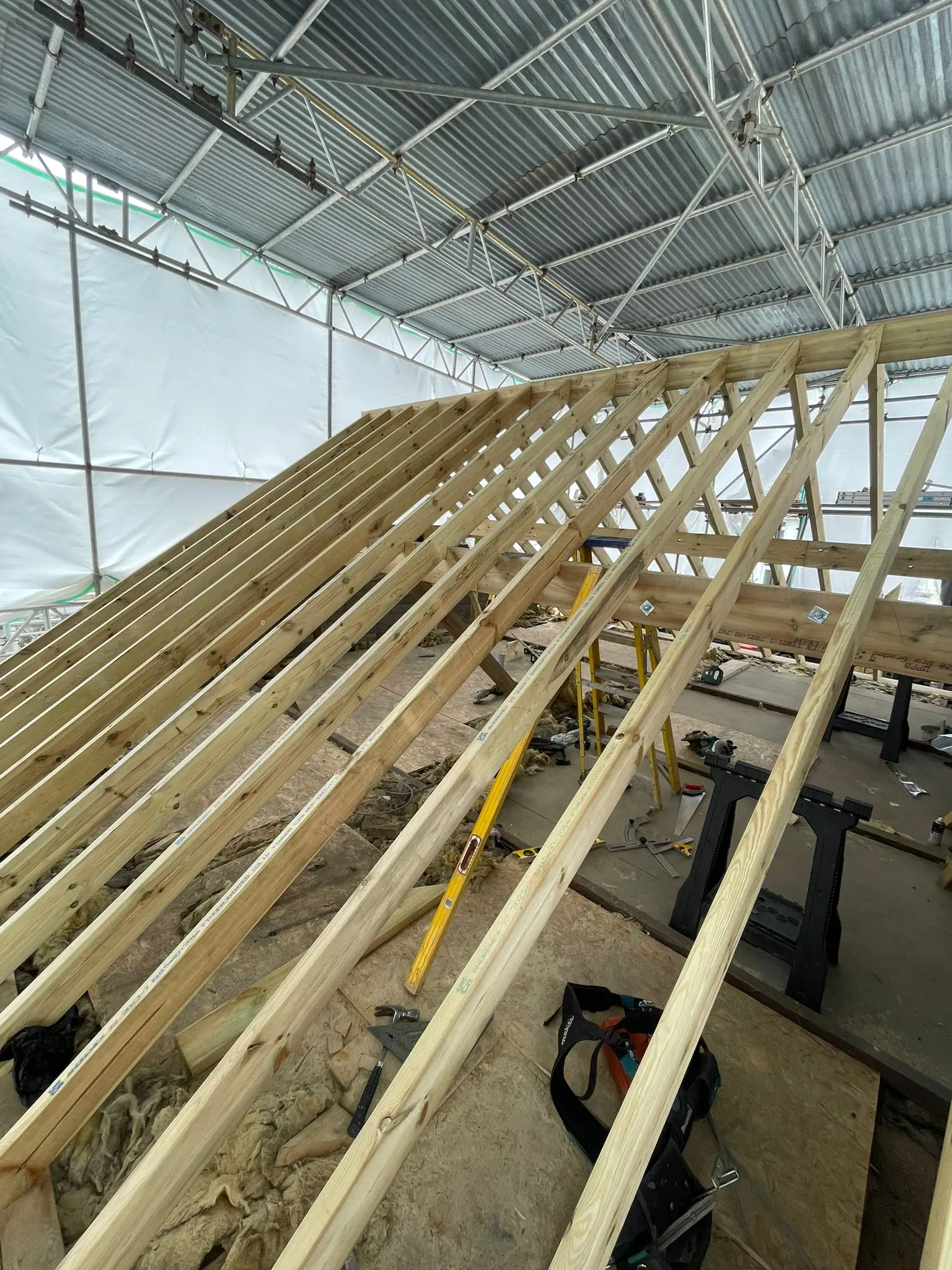 Cut roof timber structure under a temporary scaffold roof