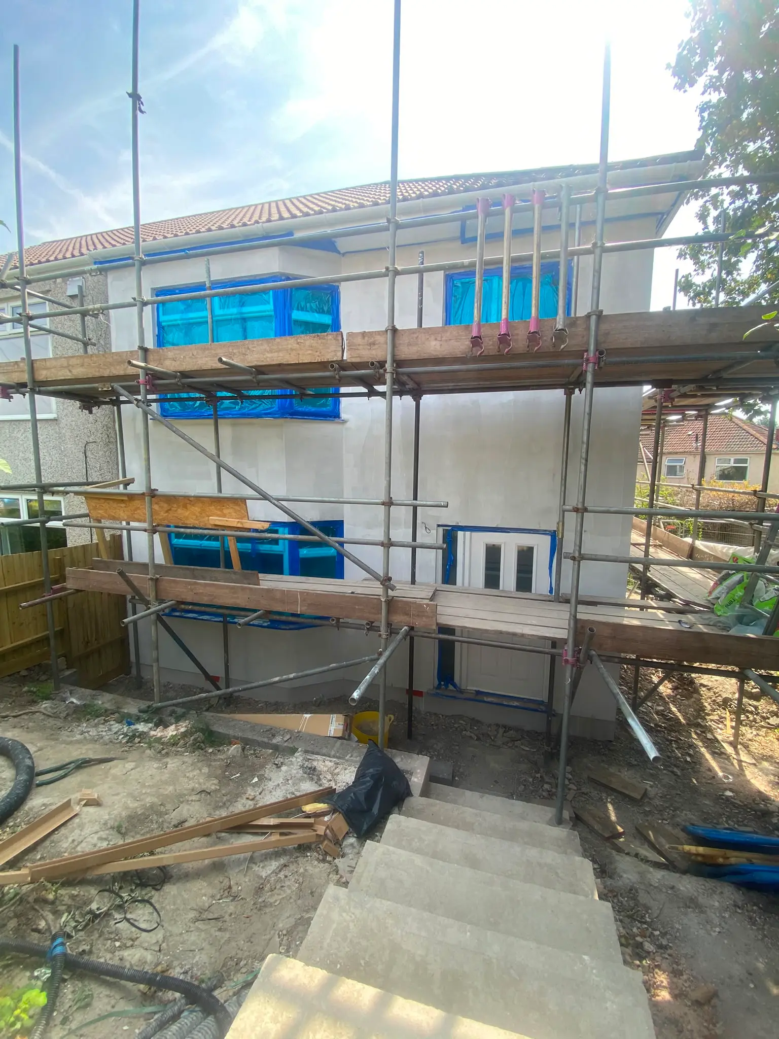 Scaffolded elevation with first-floor windows fitted