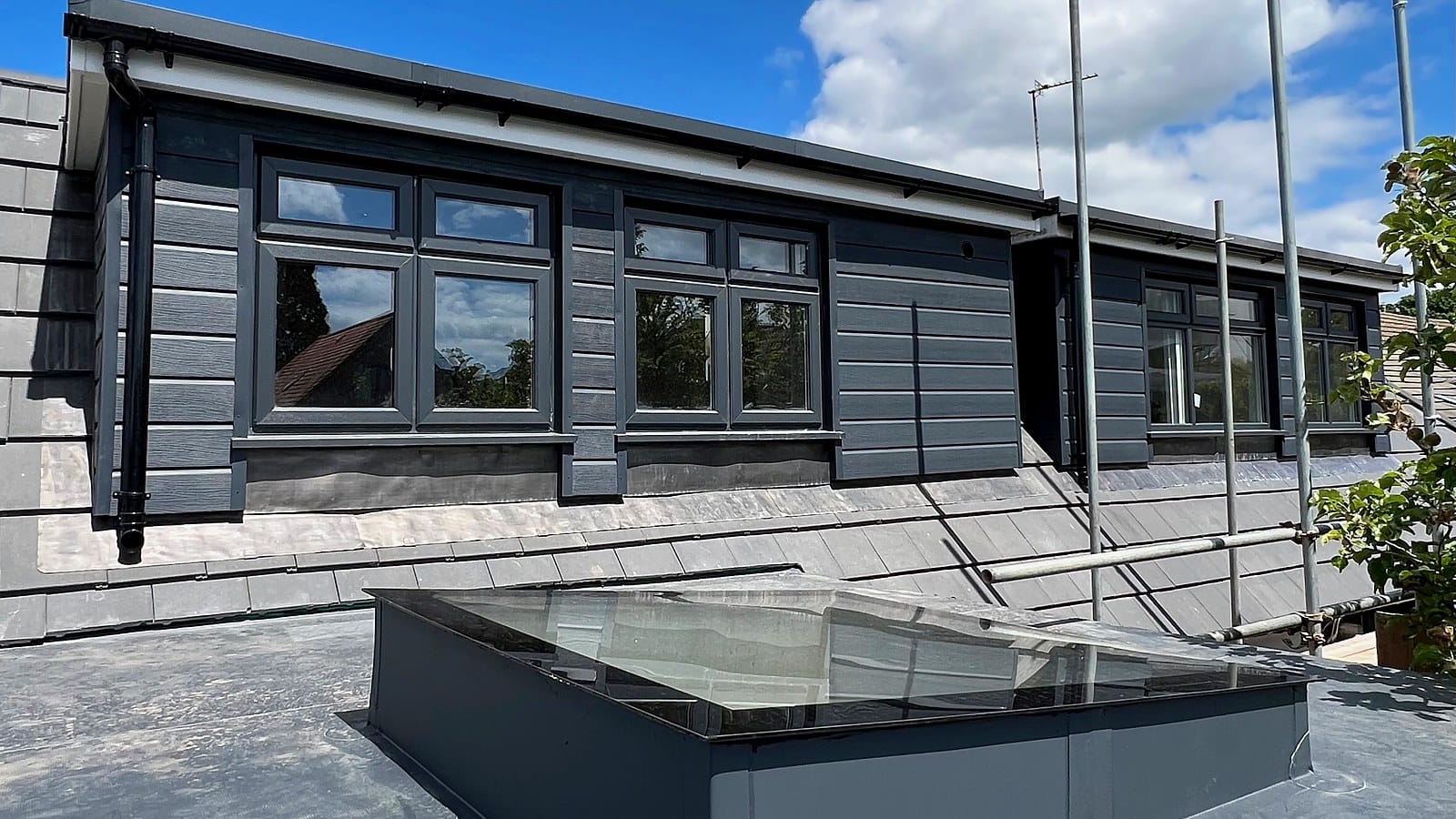 Black-clad flat-roof dormer in Bristol by Wilson & Cole, the type priced in our 2026 loft conversion cost guide