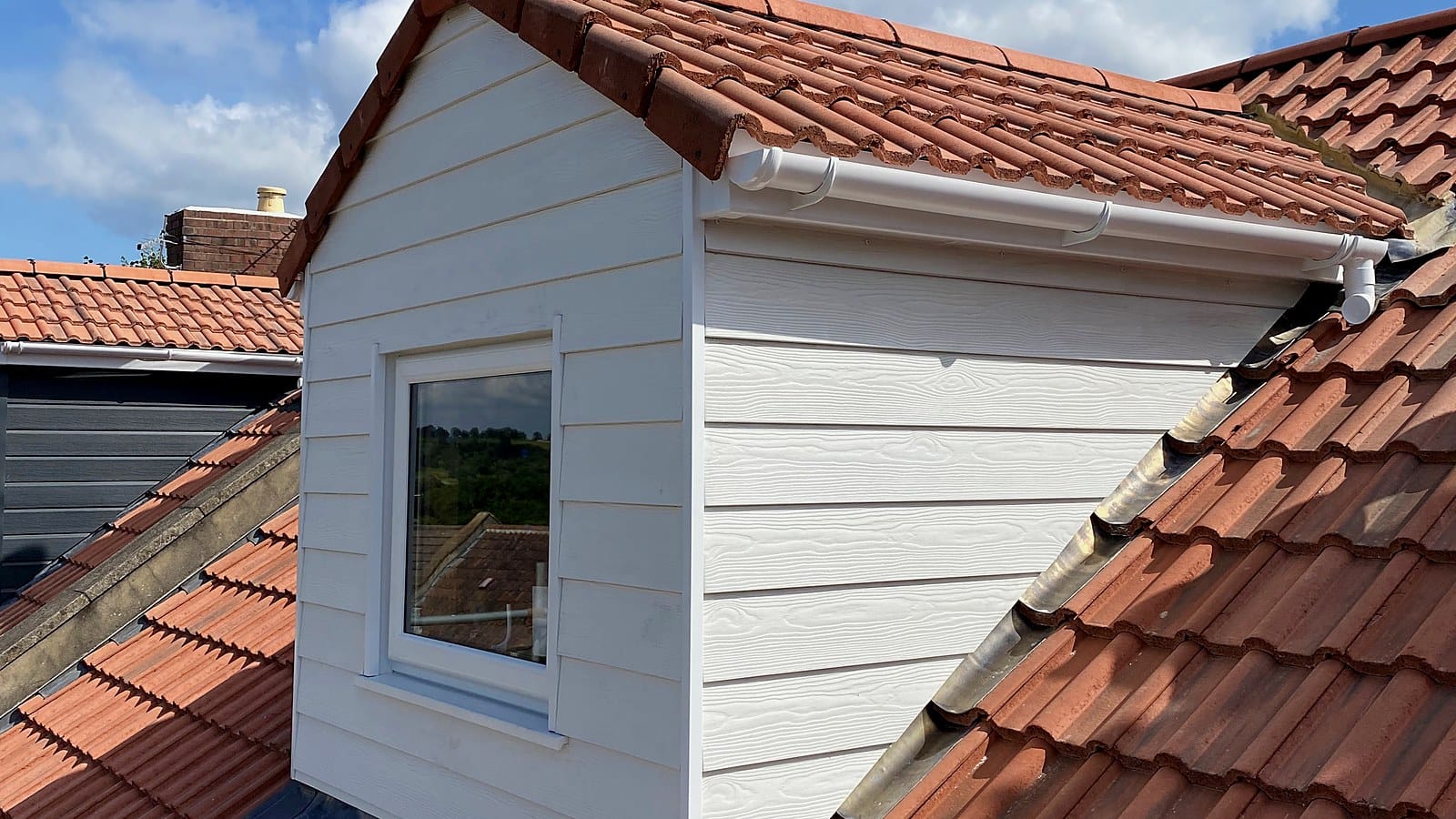 White rear dormer loft conversion on a red-tiled Bristol roof, built by Wilson & Cole