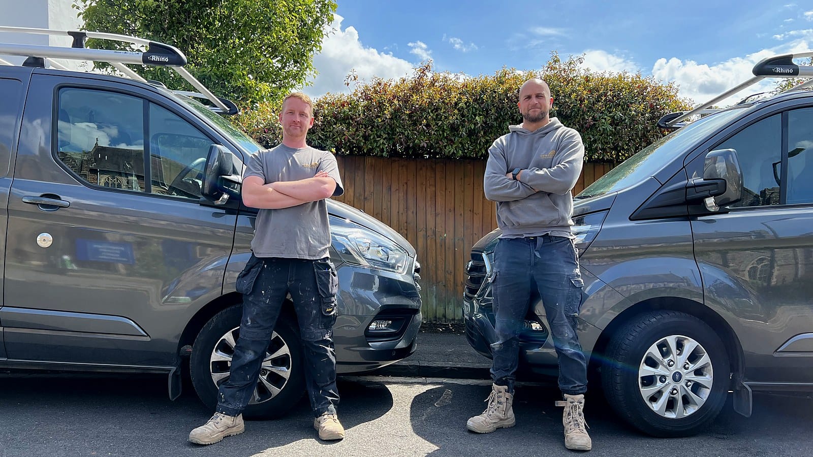 Dan and Craig of Wilson & Cole Developments standing beside their branded vans in Bristol