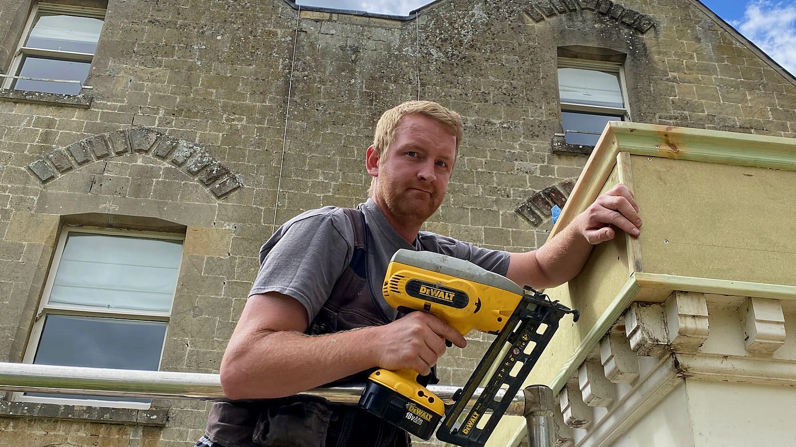 One of the Wilson & Cole founders working on scaffold at a stone house